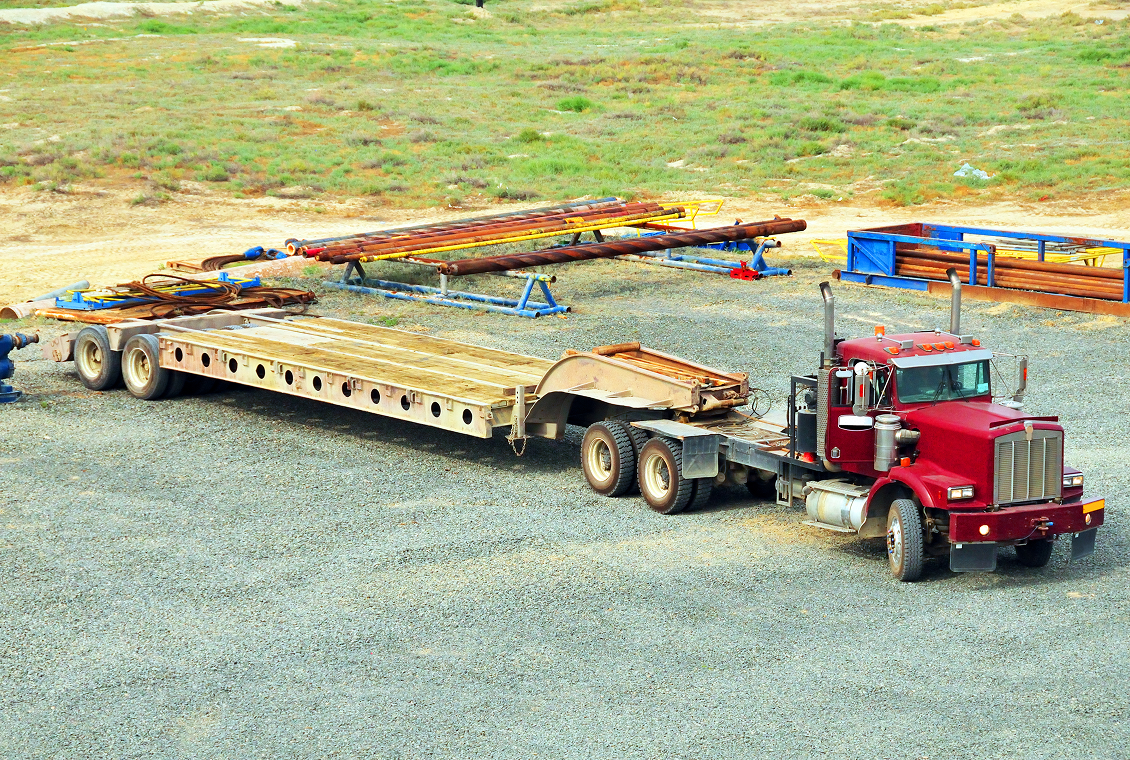 Red semi-truck with flatbed trailer