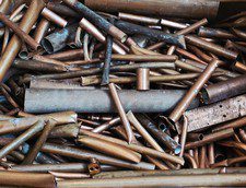 A pile of spent bullet casings in various sizes and conditions.