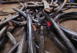 Close-up of cut electrical cables with exposed copper wires.