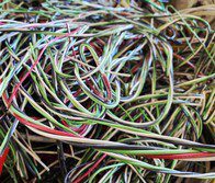 Close-up of colorful curly ribbons in shades of green, purple, and pink.