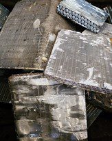 Several wrapped rectangular blocks stacked on a surface.