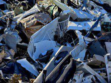 Pile of crushed and twisted metal scraps at a junkyard.