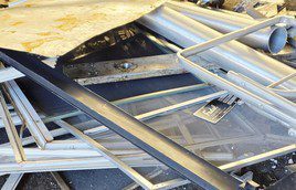 Stack of metallic ladders and frames piled together.